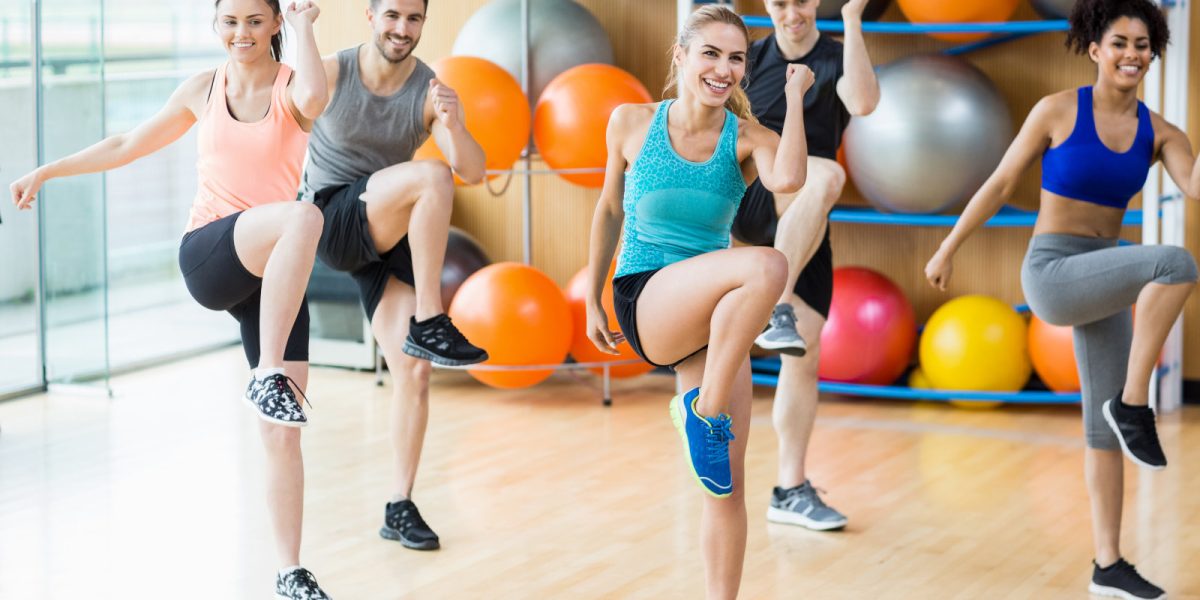 Fitness class exercising in the studio at the gym